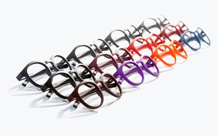 Rows of 3D-printed eyewear frames in various colors