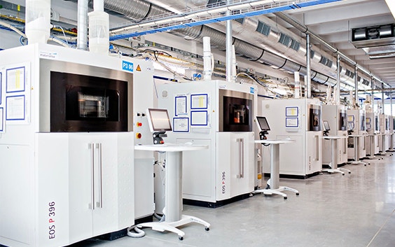 A row of EOS 3D printers at a Materialise production facility