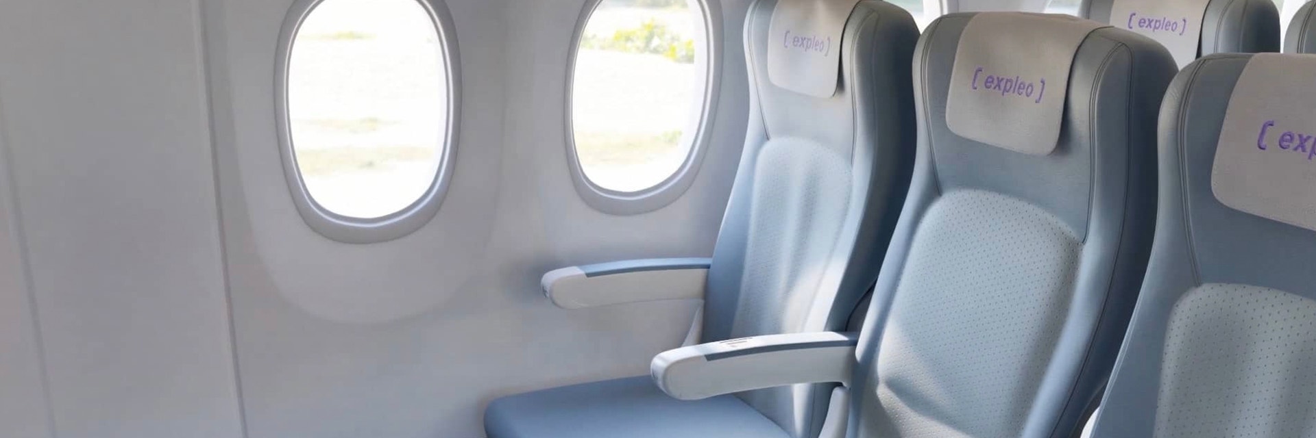 Row of three seats on an aircraft with dado panel visible at base of side wall