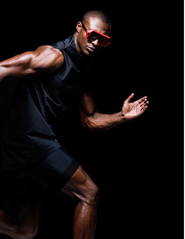 Black male model in a running position wearing sunglasses from the Vava Red Label collection