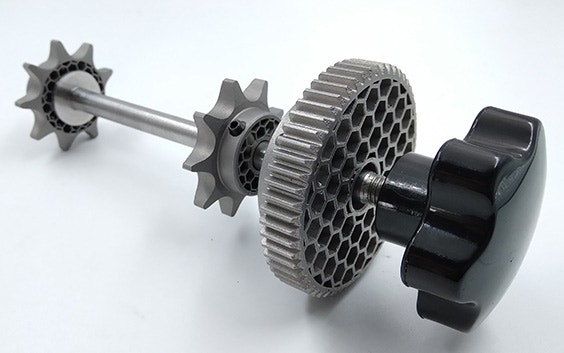 A metal shaft with 3D-printed gears and sprockets