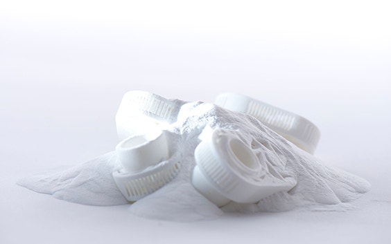 White powder bed that includes many 3D-printed parts
