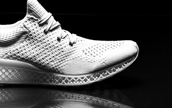 Side view of a white running sneaker with lattice structures in the bottom and its image reflected on the ground