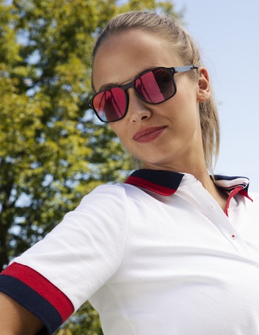 Woman in a sporty shirt, wearing McLaren Vision Openmatic sunglasses