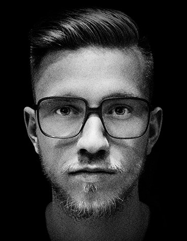 Grey-scale, extreme close-up shot of male bearded model wearing fmhofmann eyewear