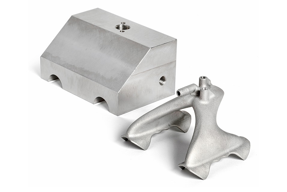 Side-by-side comparison of a production suction gripper. One is bulkier and created with conventional manufacturing methods and one is sleek and made with 3D printing