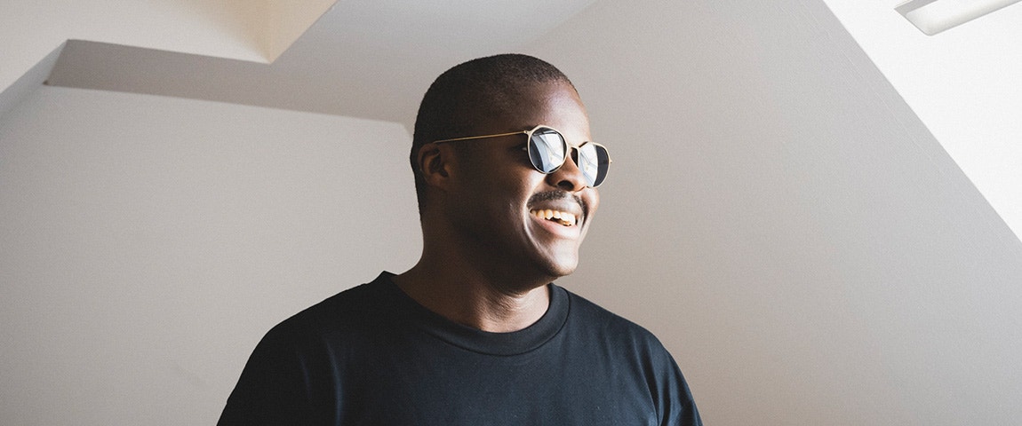 A man smiling while wearing weareannu's 3D-printed Oblique Panto 08 M eyewear frames