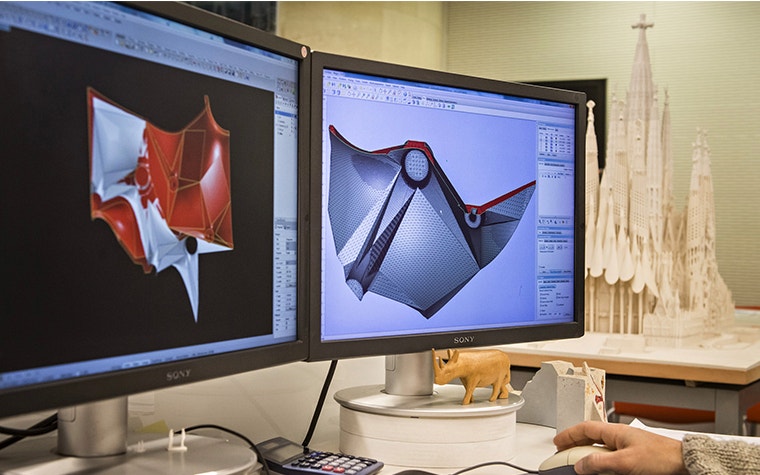 A close-up of a designer working on a PC using 3D CAD tools.