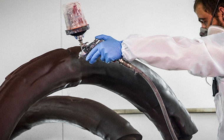 Spray painting the tusks of the 3D printed mammoth