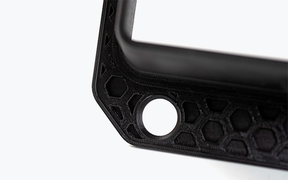 A black 3D-printed airduct frame made in PC-ABS using fused deposition modeling.