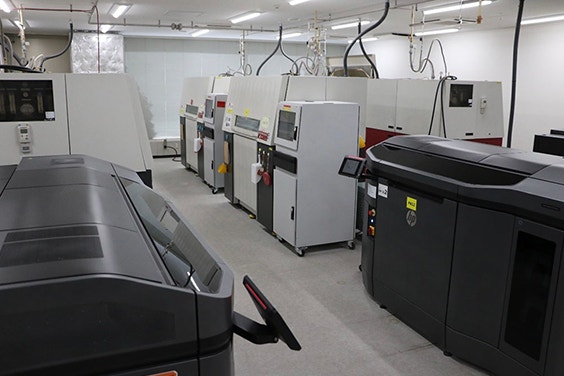 A collection of various 3D printing machines in a room