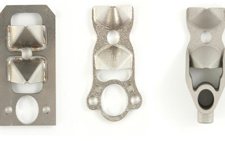 Metal lightbulb production line parts, before and after redesigning for 3D printing