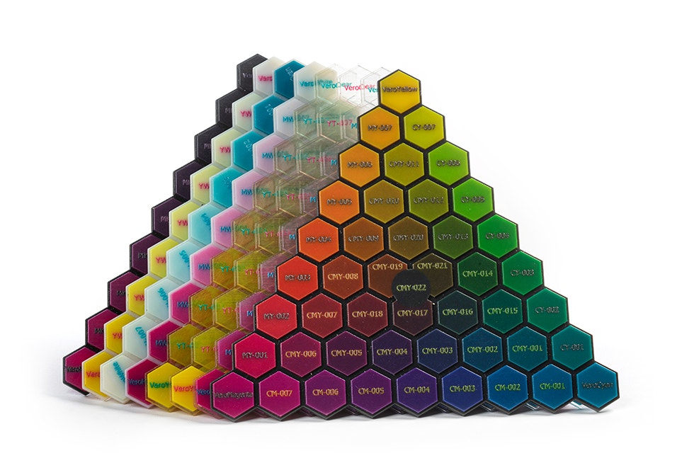 Decorative image showing rows of hexagons of different colours, printed using PolyJet