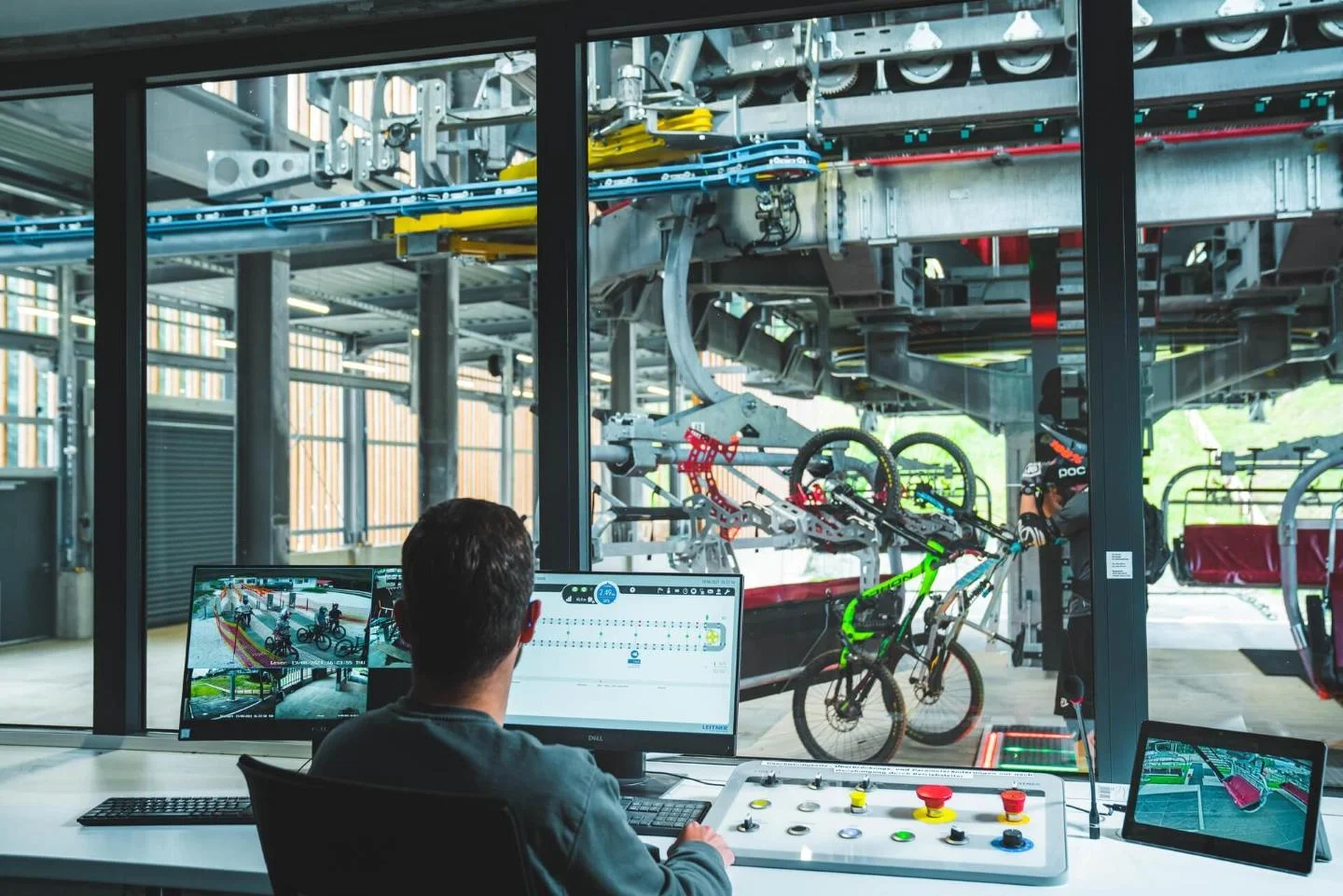 An employee looking from the control room at the chairlifts