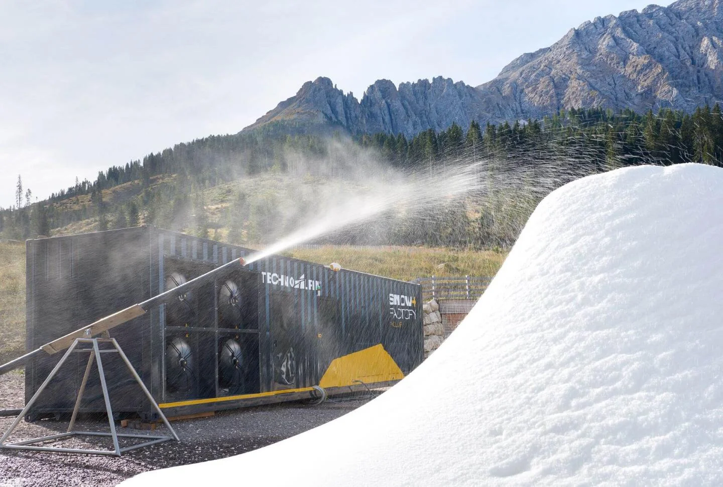 A snow cannon at the test with mountains in the background