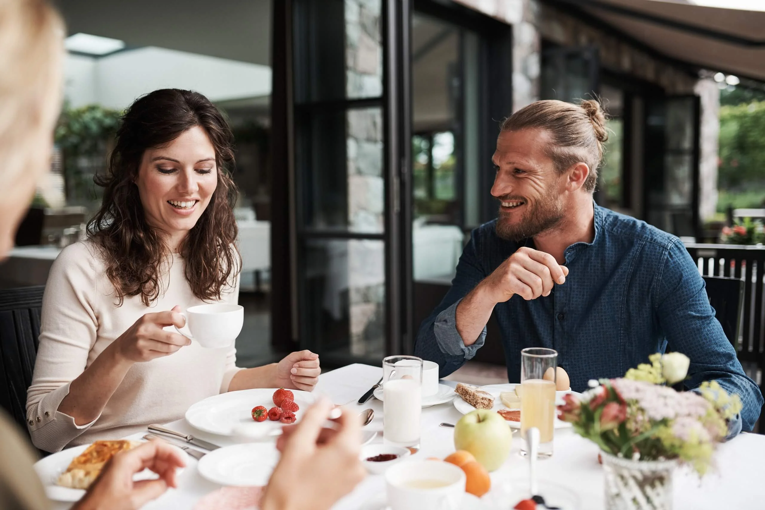 A young couple having breakfast at a set table
