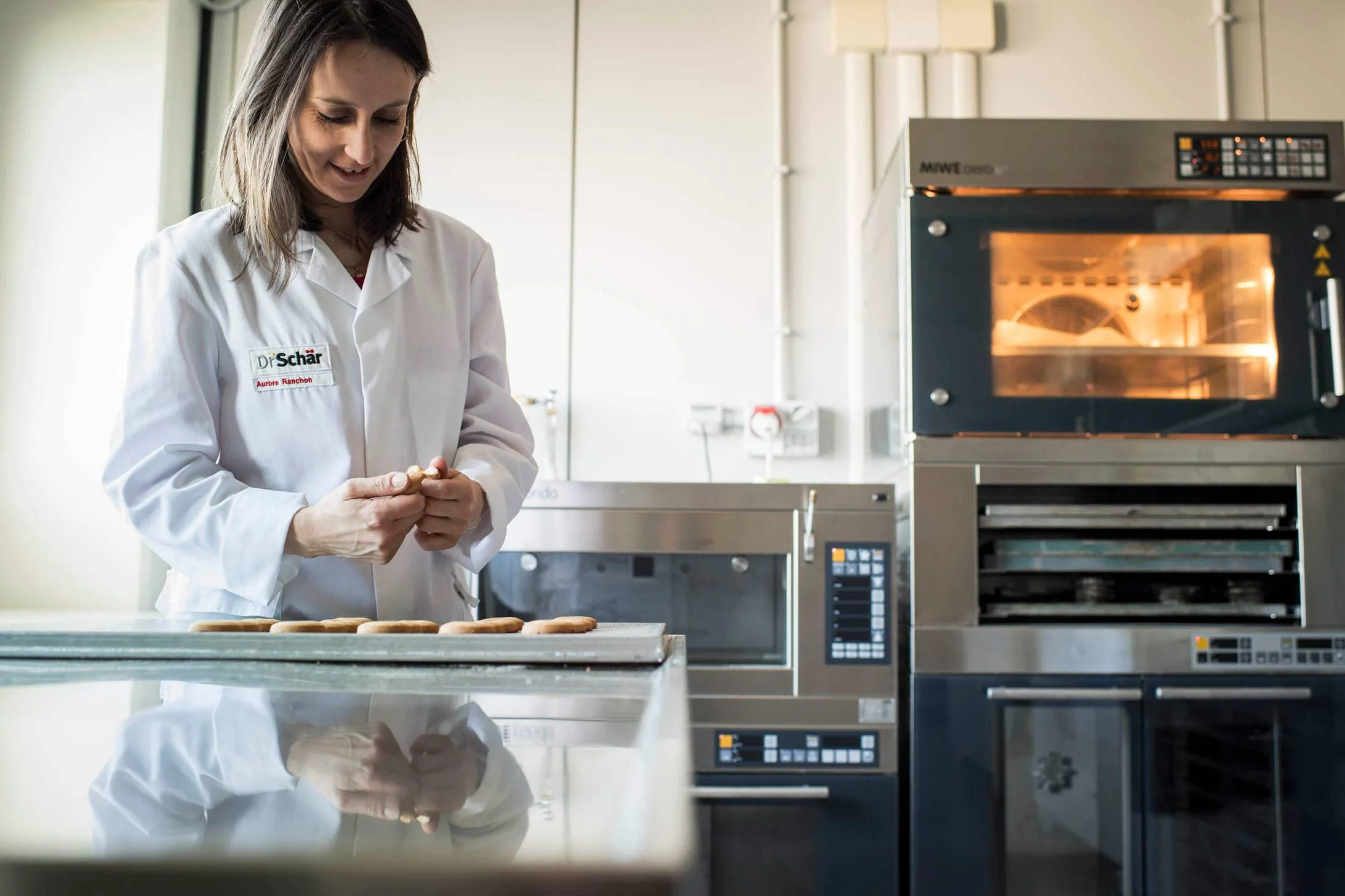 Expert in the baking lab carefully testing freshly baked goods