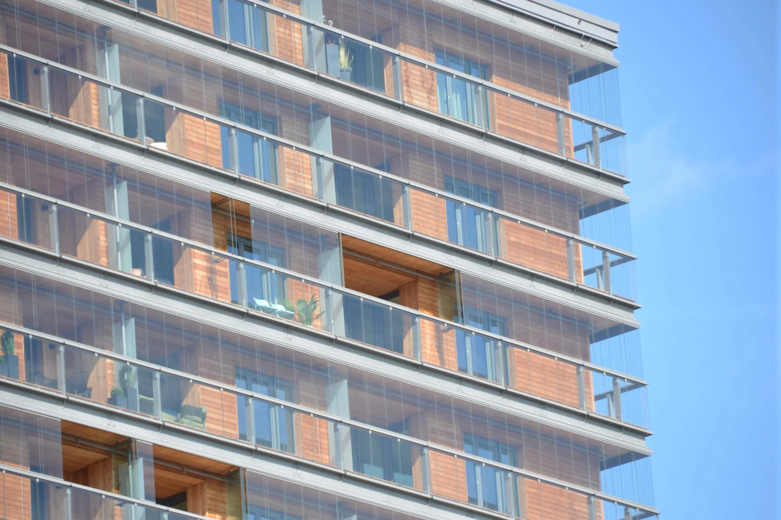 View of a multi-storey residential building with modern wooden facade