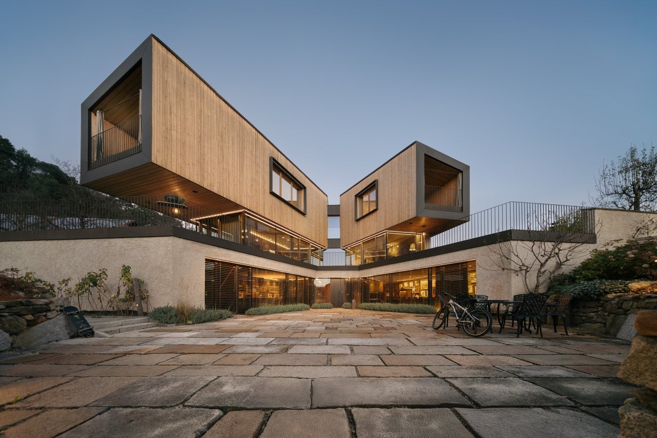Modern wooden house with stone slabs in front of the spacious entrance area