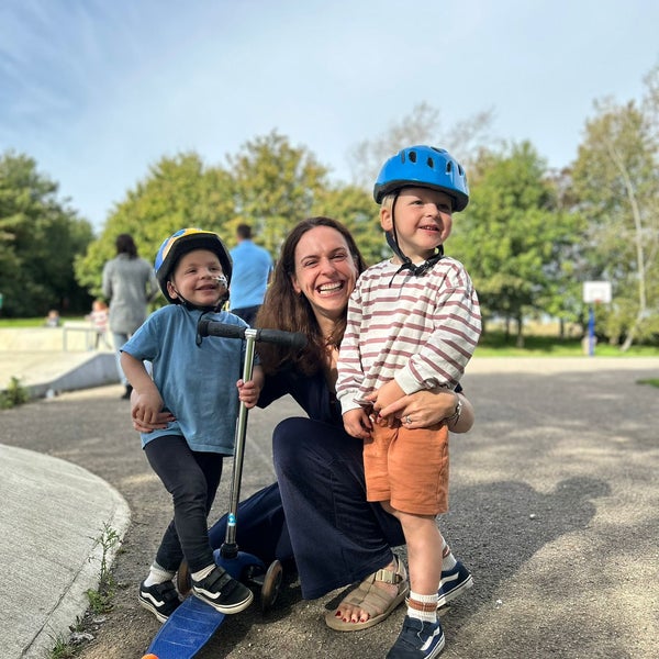 Jo Hughes with her sons smiling at the park