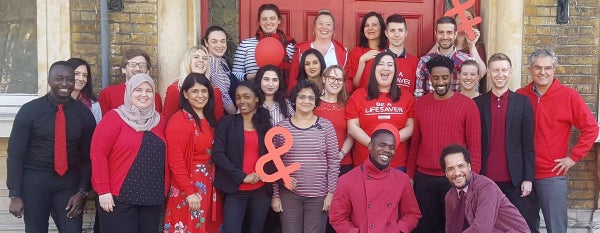 A group of DKMS staff wearing red to celebrate World Blood Cancer Day
