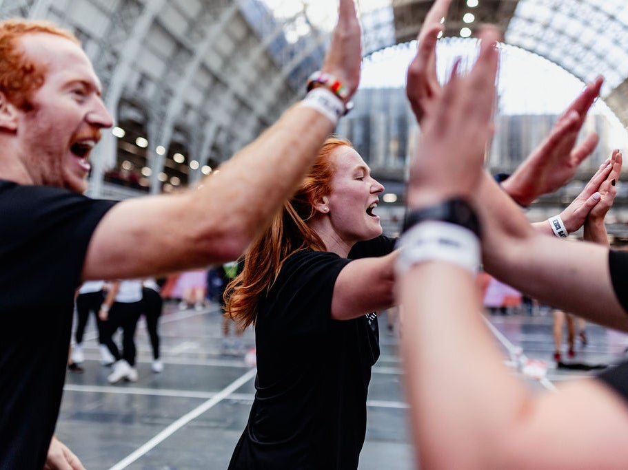 Several people giving each other high fives Several people giving each other high fives