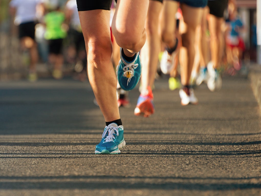 Legs of runners in a race, running on asphalt. Legs of runners in a race, running on asphalt.