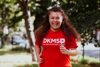 Woman running in red DKMS t-shirt