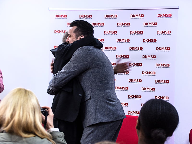 Ivor Godfrey Davies and Mark Jones hugging at DKMS UK office