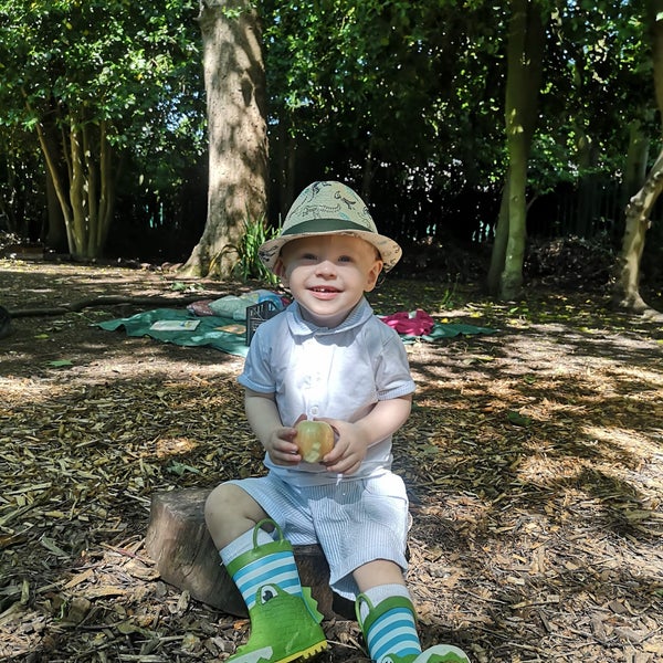 Oliver sitting on the ground in woodland Oliver sitting on the ground in woodland