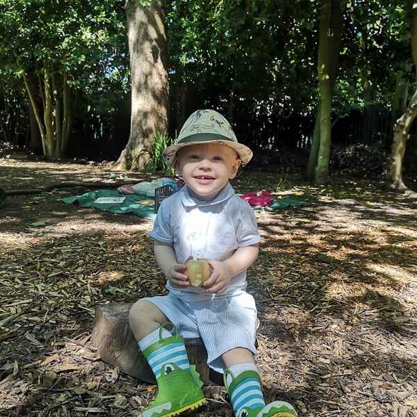 Oliver sitting on the ground in woodland Oliver sitting on the ground in woodland