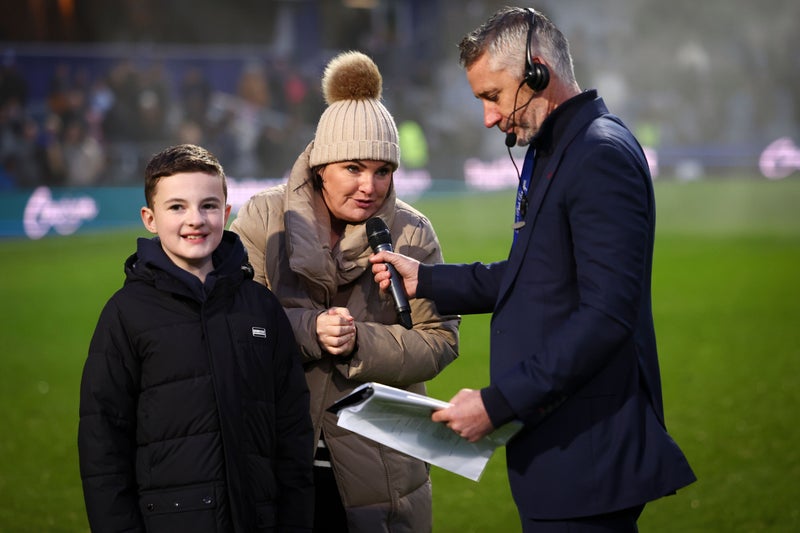 Jo and Finn Hill being interviewed on the pitch by Paul Morrissey, QPR at half time