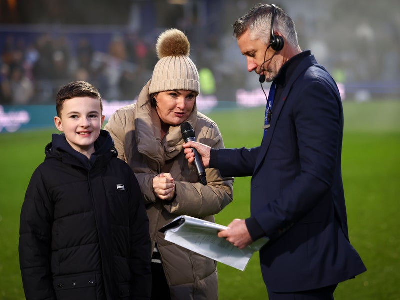 Jo and Finn Hill being interviewed on the pitch by Paul Morrissey, QPR at half time