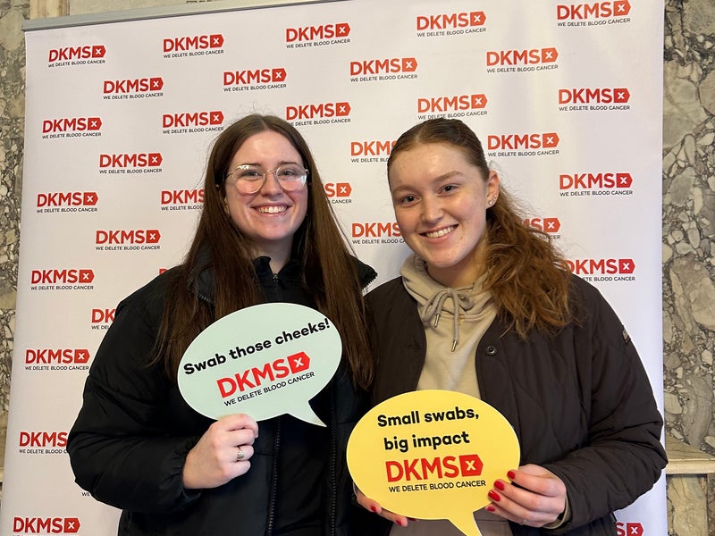Two females smiling at a DKMS event