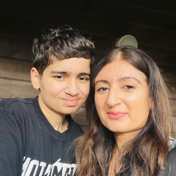A selfie with a woman and her son smiling A selfie with a woman and her son smiling