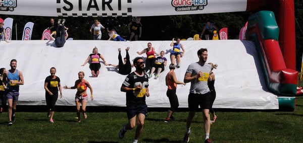 Runners at an inflatable obstacle course