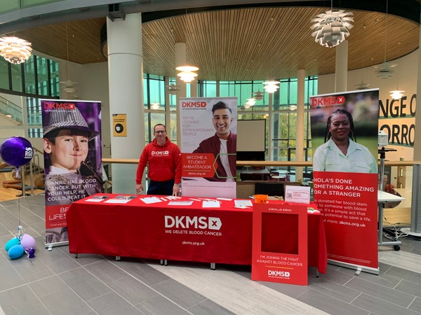 DKMS volunteer at a donor drive recruitment stand
