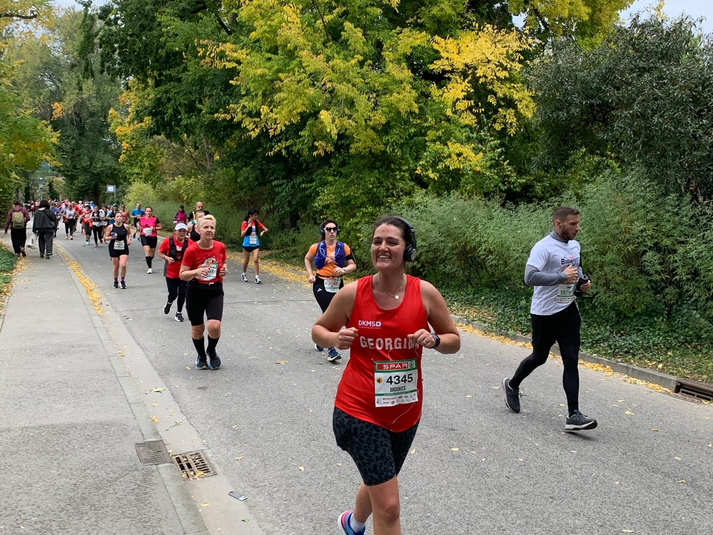 Woman running in a DKMS vest Woman running in a DKMS vest
