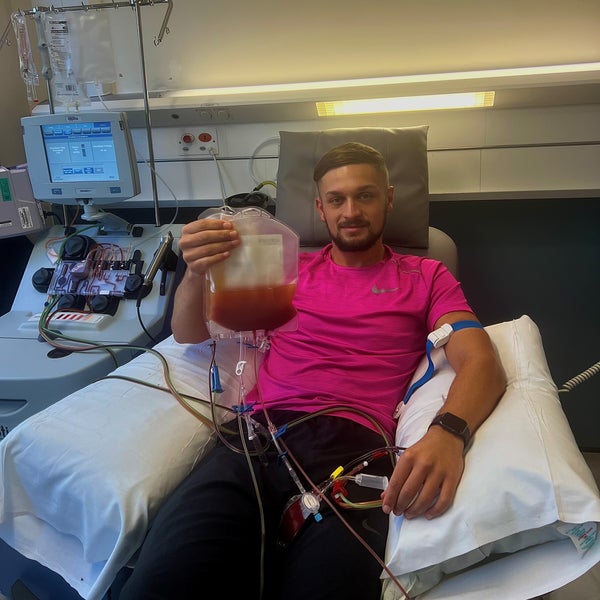 Middle age man on a hospital bed holding a bag of stem cells Middle age man on a hospital bed holding a bag of stem cells