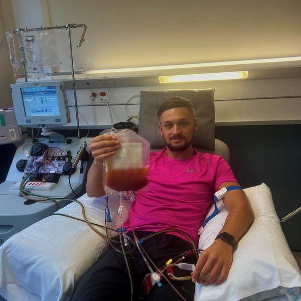 Middle age man on a hospital bed holding a bag of stem cells Middle age man on a hospital bed holding a bag of stem cells