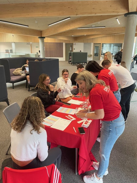 DKMS UK Volunteers working and sitting together at a table