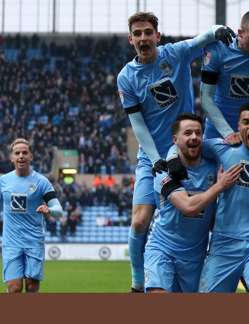 Jubilent Coventry City players celebrate goal Against Swindon Town
