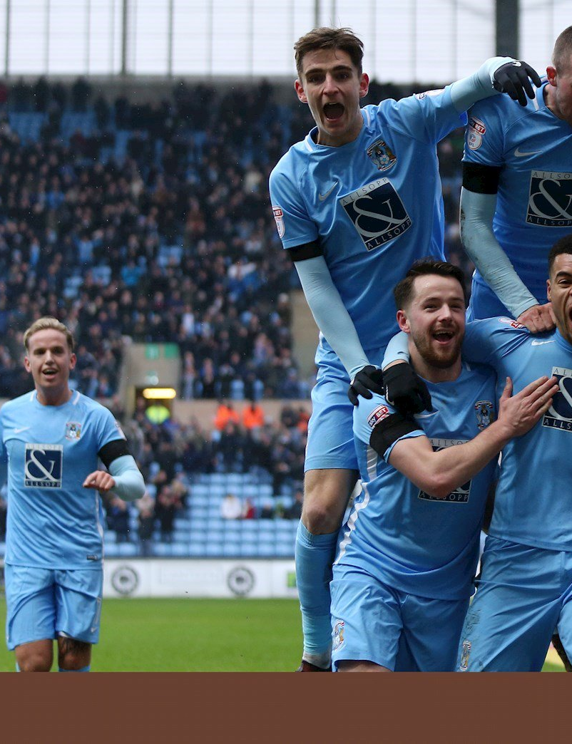 Jubilent Coventry City players celebrate goal Against Swindon Town 