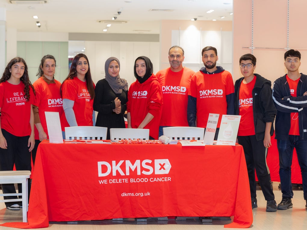 DKMS volunteers at event standing together DKMS volunteers at event standing together