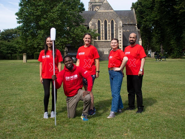 Five DKMS staff with a giant swab