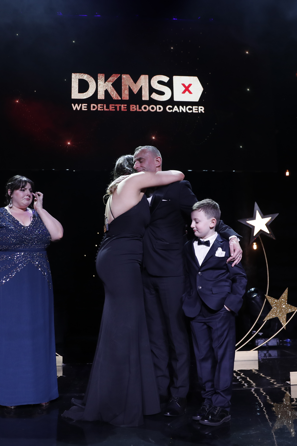 Leah McDougall and James O'Donnell hug at DKMS Gala in London