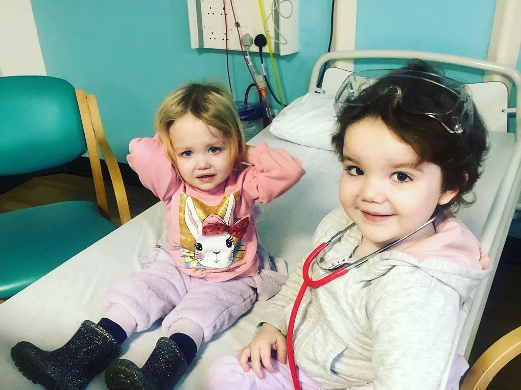 Josie and Adeline sitting together on a hospital bed Josie and Adeline sitting together on a hospital bed