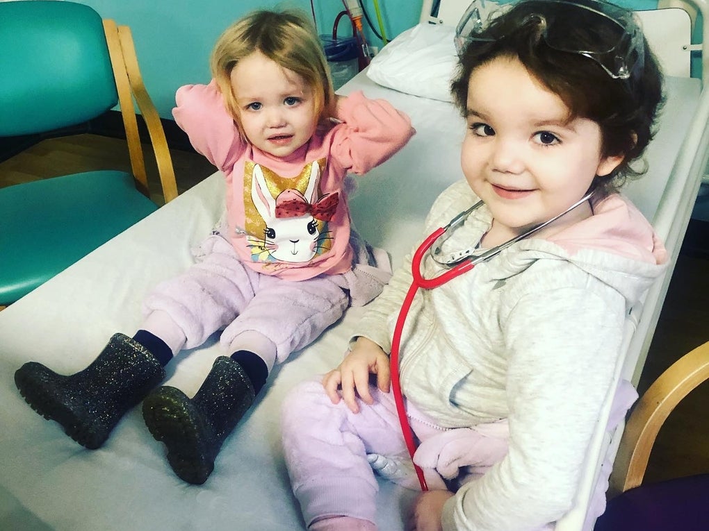 Josie and Adeline sitting together on a hospital bed Josie and Adeline sitting together on a hospital bed