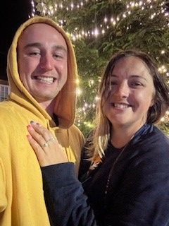 Ben and Amy smiling with her new engagement ring