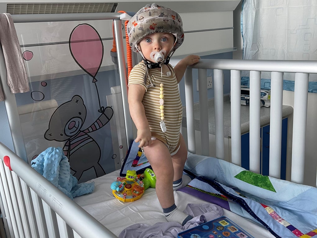 Gustavs wearing a protective hemet standing in a hosptal cot Gustavs wearing a protective hemet standing in a hosptal cot